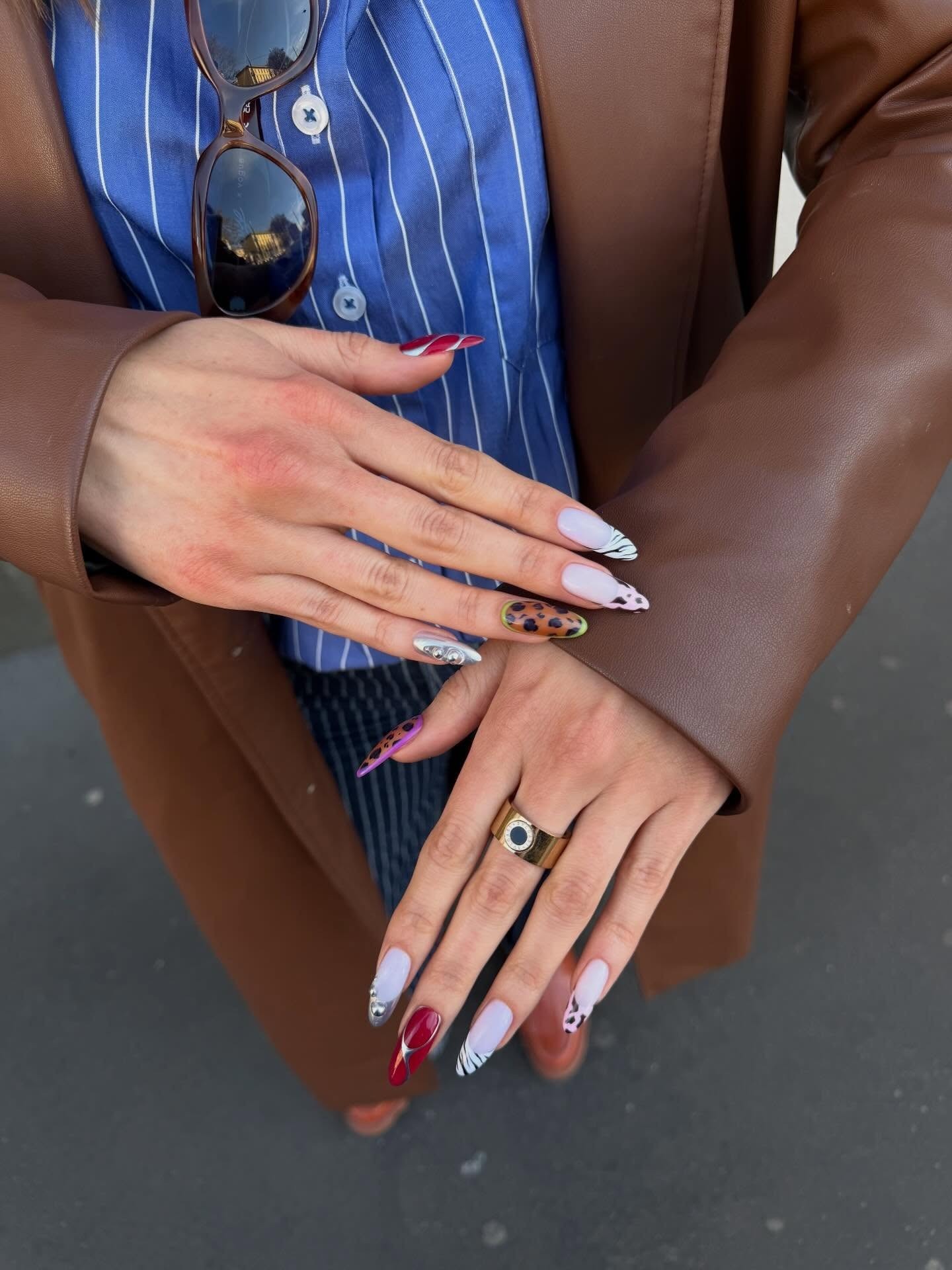 A colourful nail art design with zebra accent nails