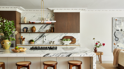 open plan kitchen with marble counters and backsplash, wooden cabinetry, and crown molding