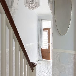 hallway with white walls and white staircase