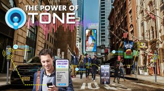 People walk a busy city street using TONE and VidOVation technologies on their phones.