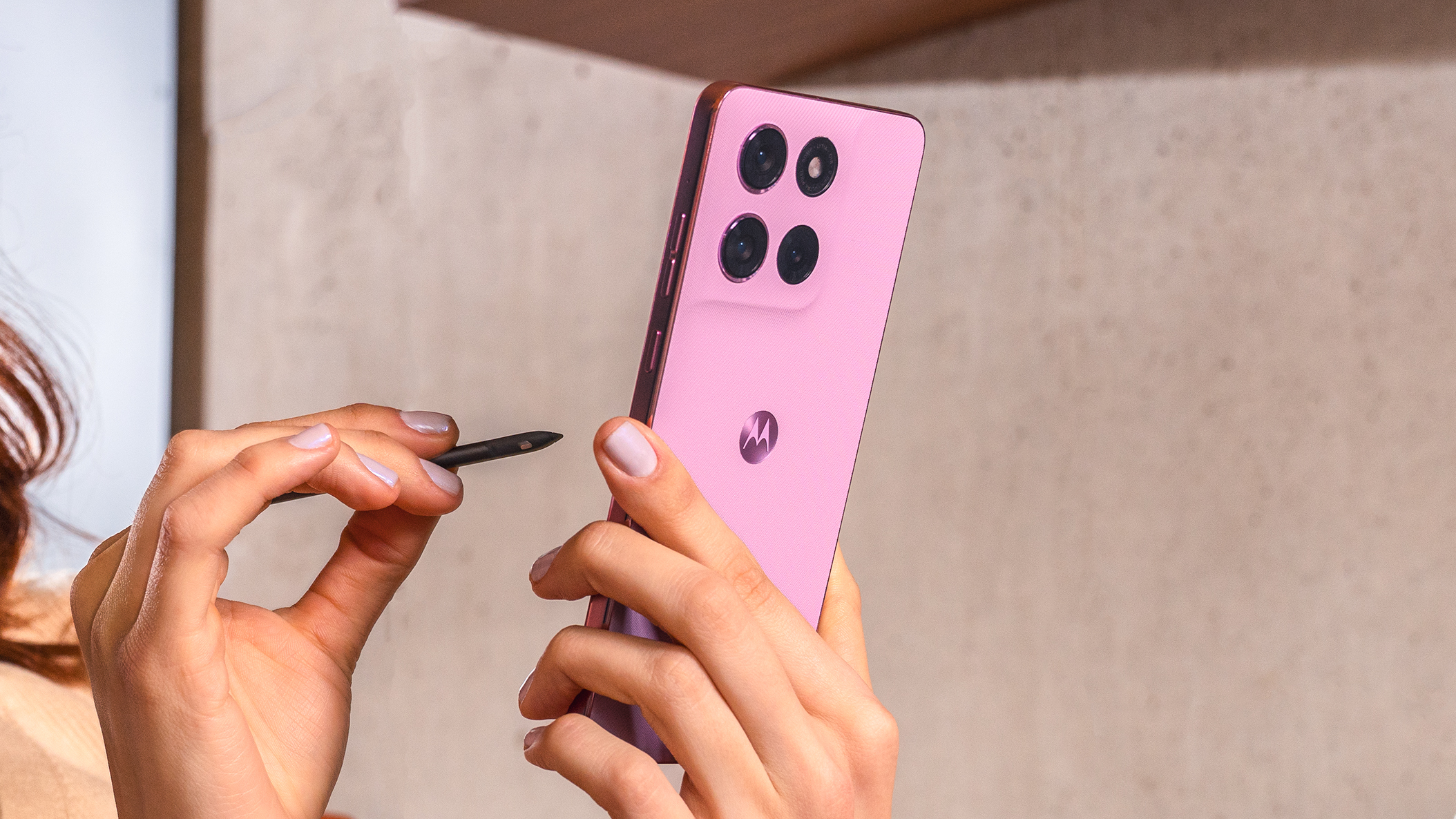 Moto G Stylus (2026) held in the hand with stylus.