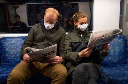People wear masks on the London Underground.