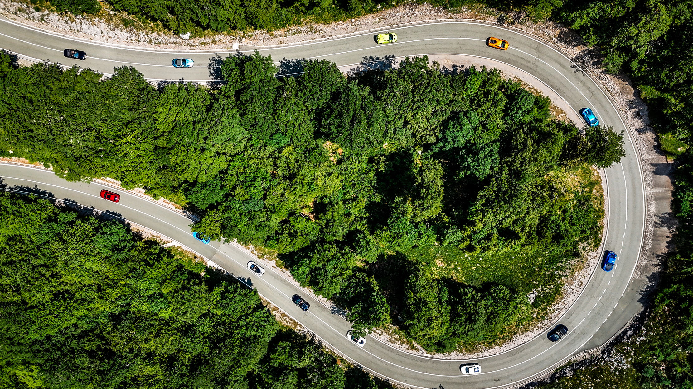 Aerial view of cars taking a hairpin bend