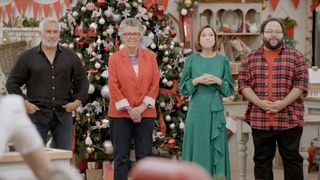Paul Hollywood, Prue Leith, Ellie Kemper and Zach Cherry standing in the tent in The Great American Baking Show Celebrity Holiday