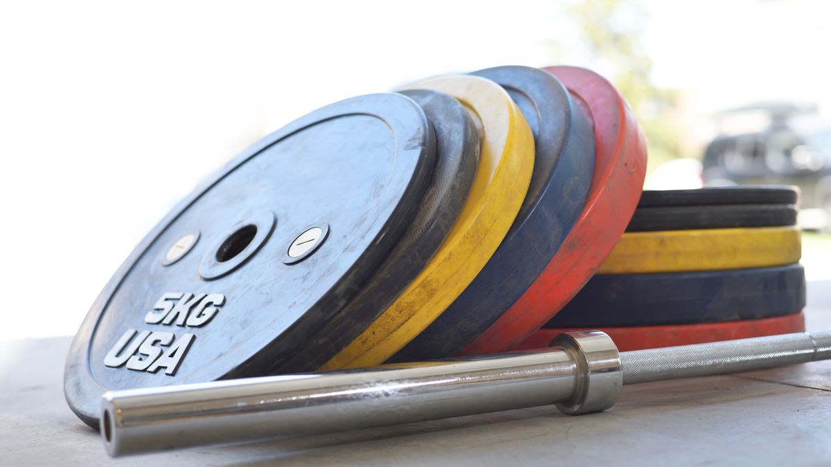 Rubber bumper plates next to barbell