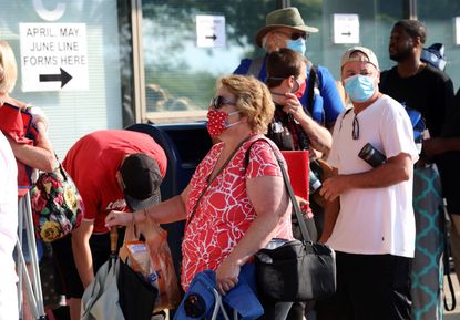 Hundreds of unemployed Kentucky residents wait in long lines outside the Kentucky Career Center for help with their unemployment claims on June 19, 2020 in Frankfort, Kentucky