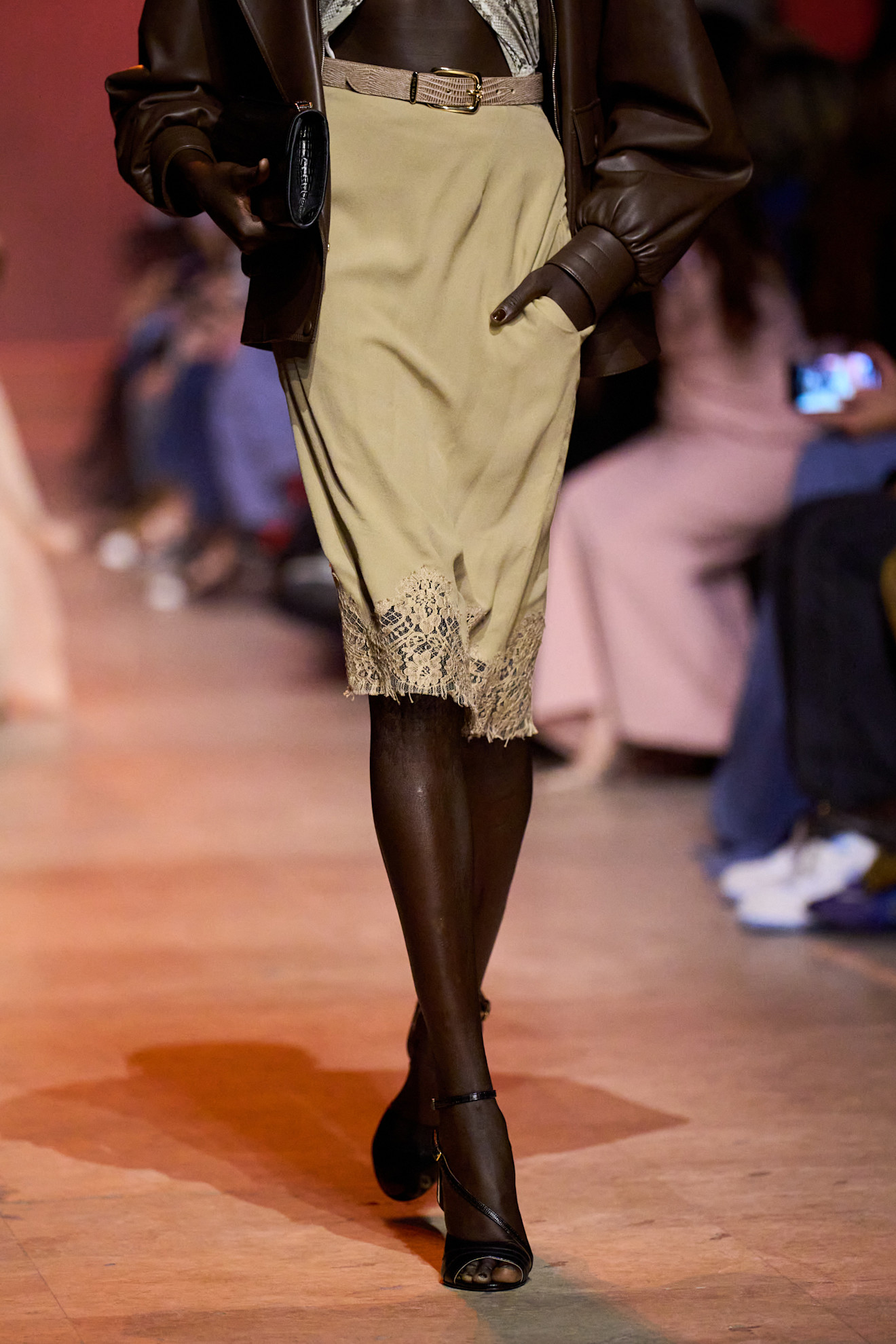 Woman in a belted lace-trim slip skirt