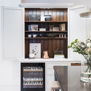 kitchen with white wall and wooden showcase