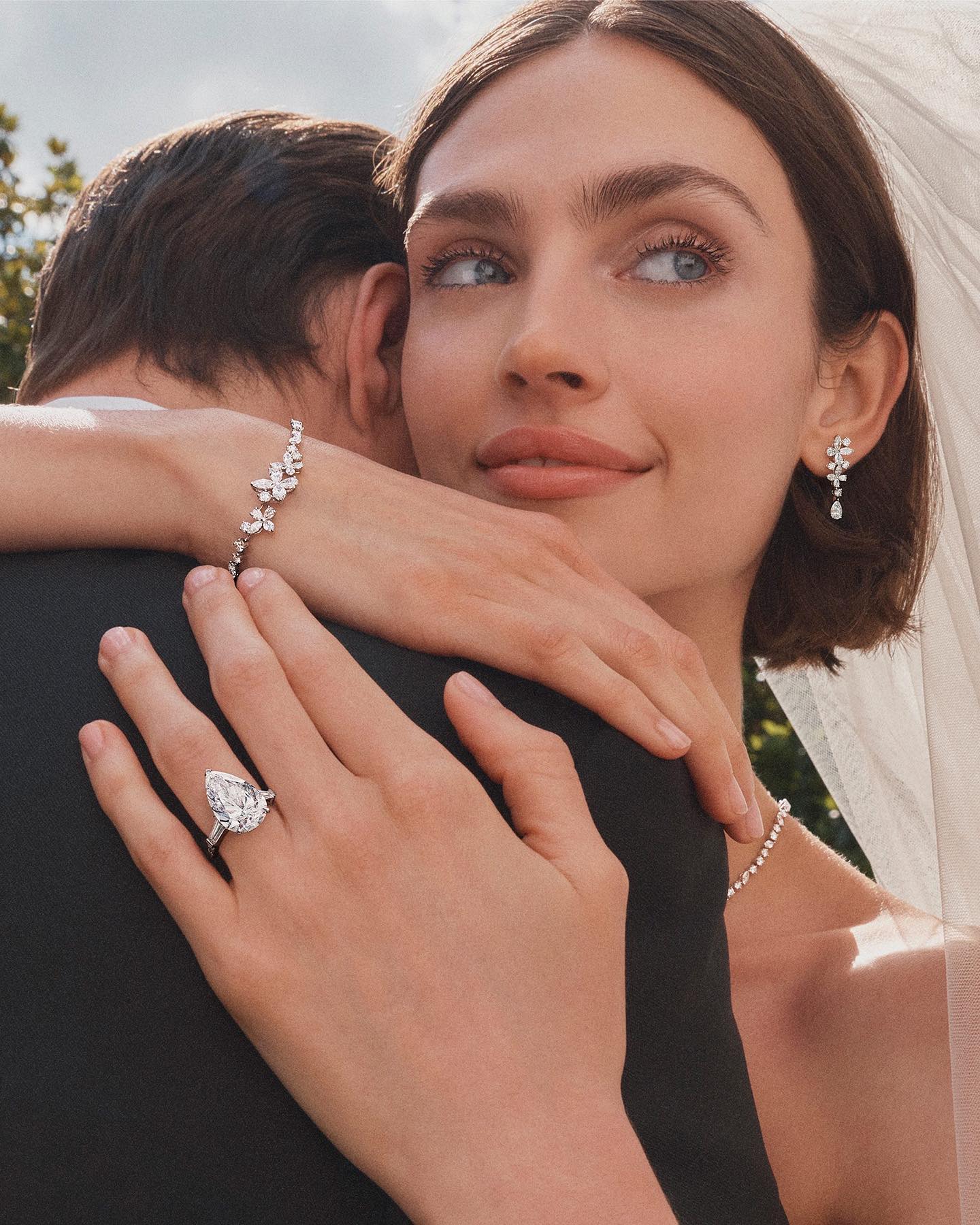 Woman wearing luxury engagement ring.
