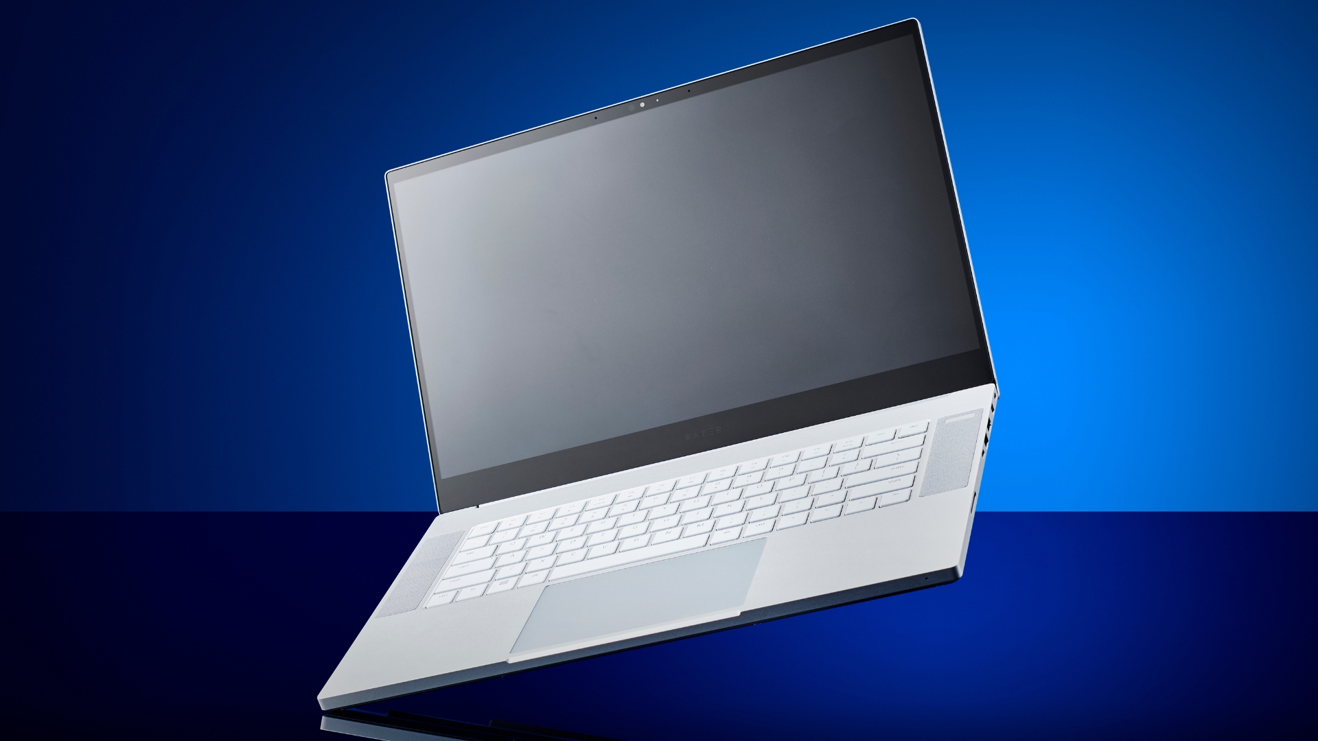 A Razer Blade 15 Studio Edition laptop on a blue background