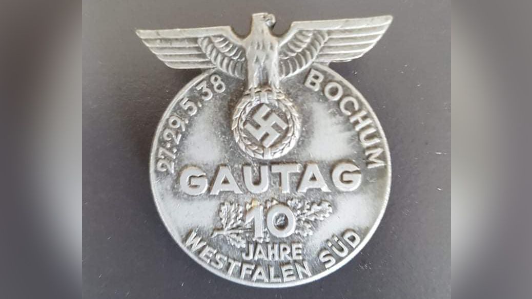 The finds include Nazi badges and medals adorned party emblems, such as eagles and swastikas.