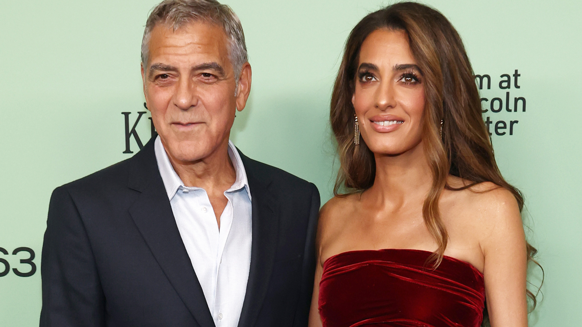 Amal Clooney wore a red velvet mini dress from Oscar de la Renta Fall 2025 at the Jay Kelly premiere
