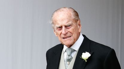 Britain's Prince Philip, Duke of Edinburgh waits for the carriage carrying Princess Eugenie of York and her husband Jack Brooksbank to pass at the start of the procession after their wedding ceremony at St George's Chapel, Windsor Castle, in Windsor, on October 12, 2018. (Photo by Alastair Grant / POOL / AFP) (Photo by ALASTAIR GRANT/POOL/AFP via Getty Images)