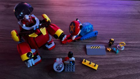 Lego Sonic vs. Dr. Eggman&#039;s Death Egg Robot set, fully constructed and laid out on a wooden surface