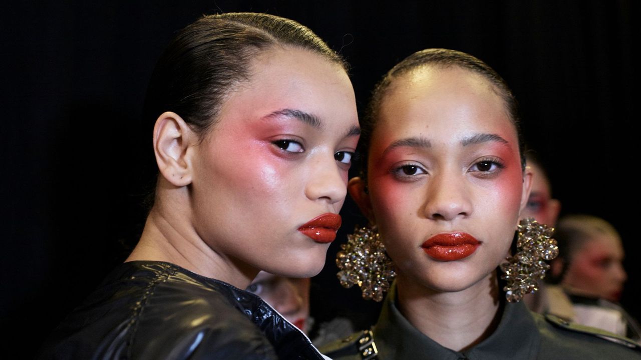 best moisturiser for sensitive skin - two models backstage at Kenzo fashion show with red makeup on cheeks - GettyImages 615680612