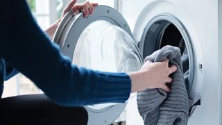 loading clothes into a washing machine