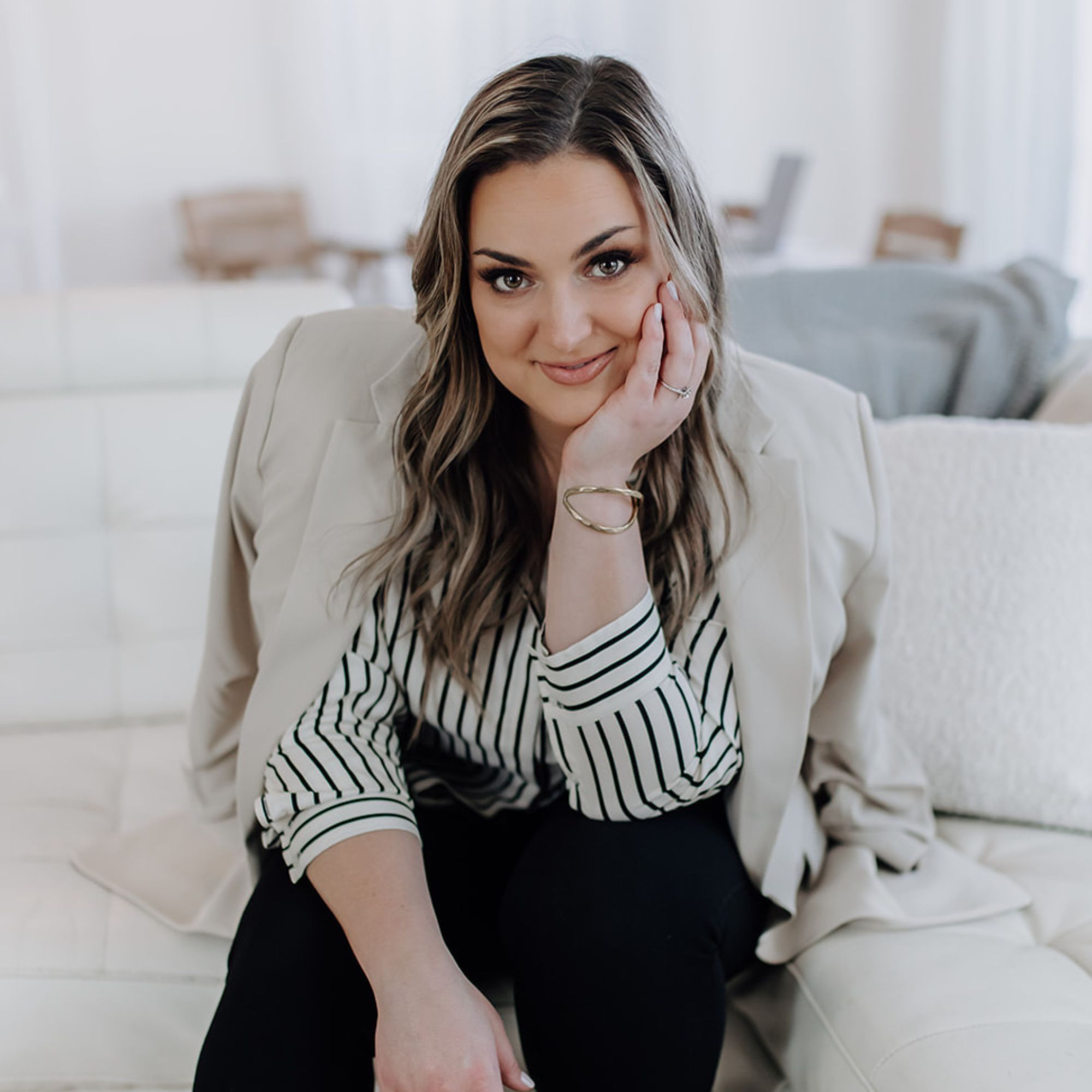 A picture of Jolynn Hansen sitting on a white couch