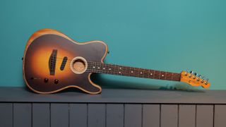 Fender Acoustasonic Telecaster against a blue wall in our photo studio