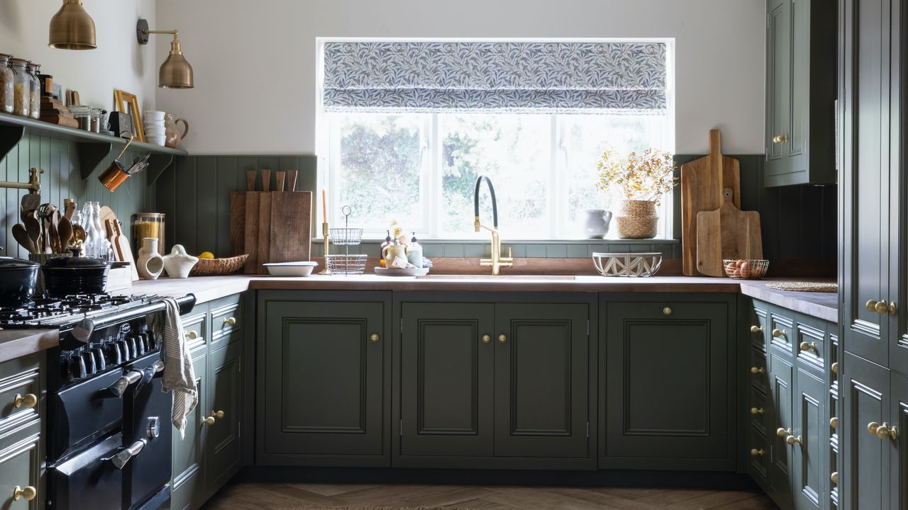 dark green inframe wooden kitchen with black AGA range cooker