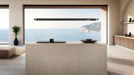 Modern kitchen with ocean views and a countertop with SMEG Pro Alta Isola hob and suspended light rail