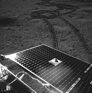 Yutu-2 imaging one of its solar panels and tracks made during lunar day six.