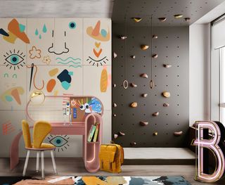 black climbing wall in children's bedroom with drawing on wall