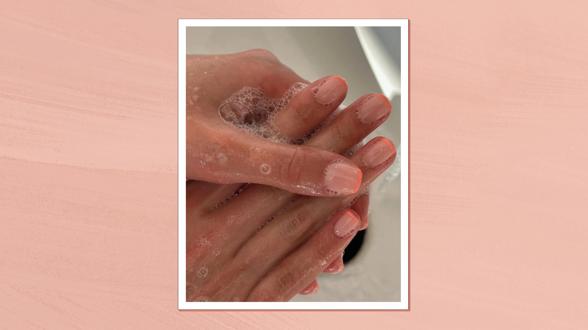 A close-up of someone washing their hands, with their nails featuring a peach French tip manicure by nail artist, Fliss Alton (@gelsbyfliss)/ featured in a peach template