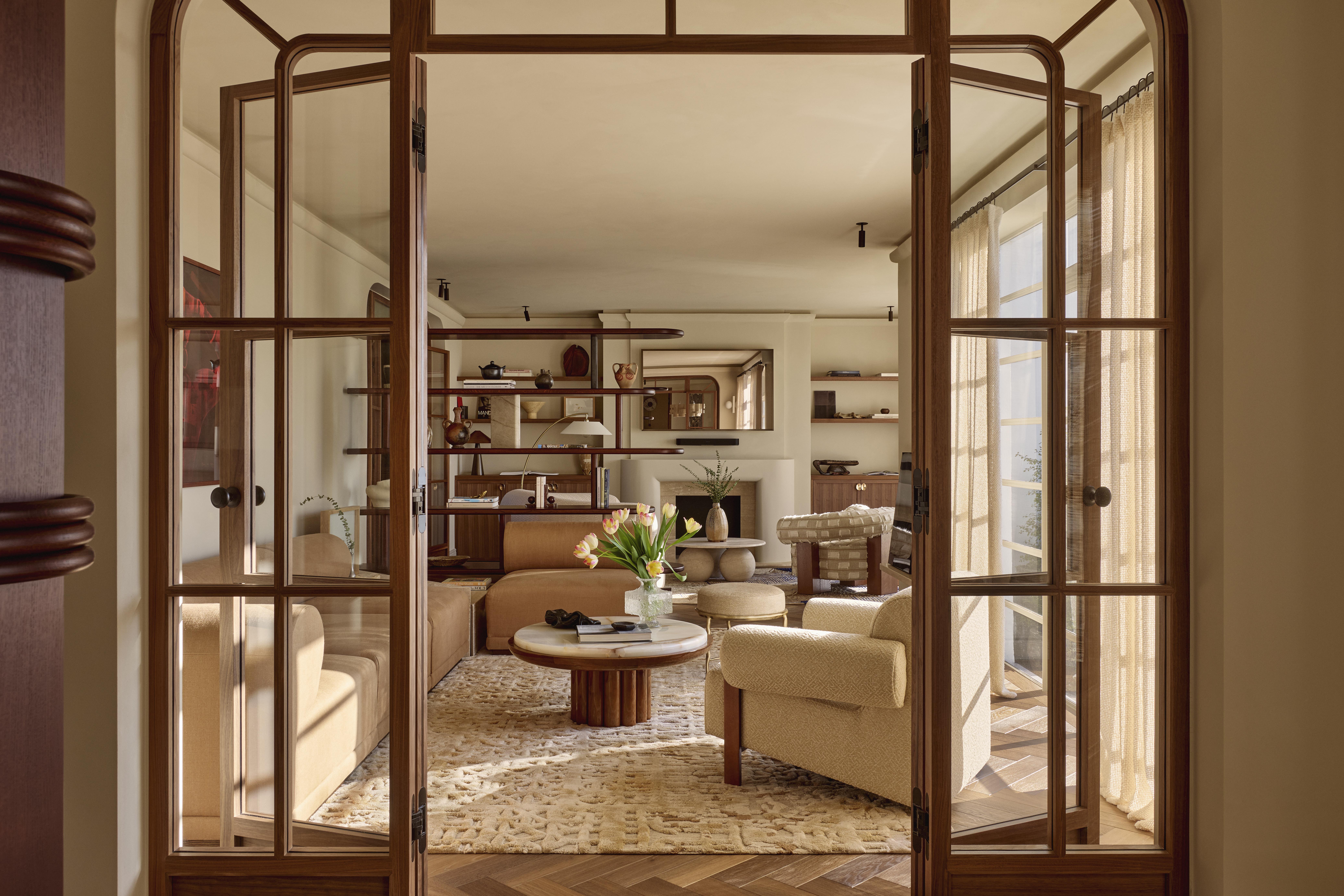 Views of open living space divided into a TV and sitting area