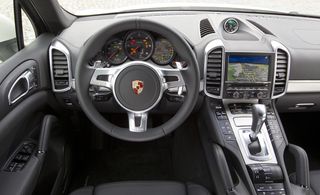 Grey leather interior with the Porsche crest in the middle of the steering wheel