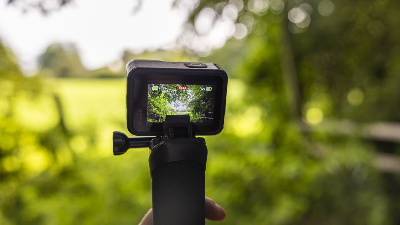 A GoPro Hero 10 Black on a floaty handler in a forest