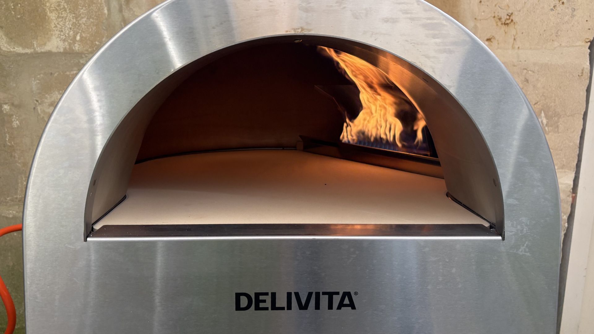 Testing the Delivita Flow Dual Fuel Pizza Oven with a fire lit inside it