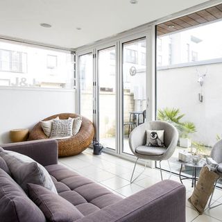 garden room with white wall and sofa