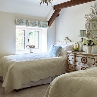 guest bedroom with separate beds and chest of drawers