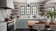 A blue kitchen with marble countertops