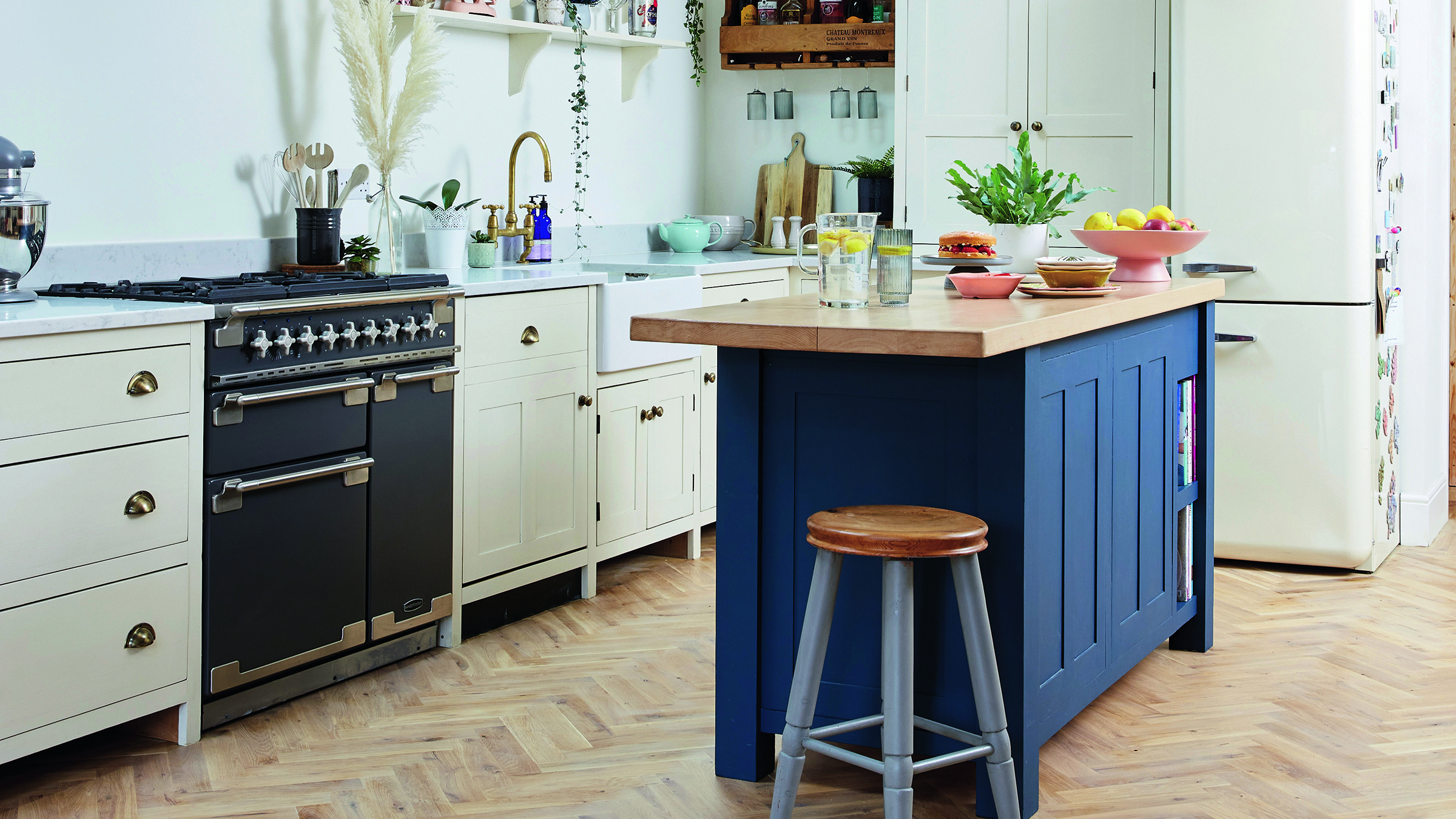 Navy kitchen island in centre of cream kitchen