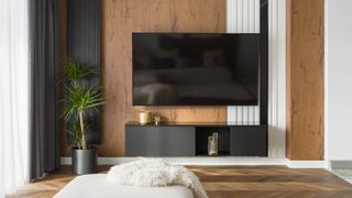 TV on wooden panelled wall