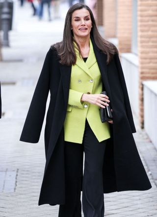 Queen Letizia in a green blazer with a black coat on topi