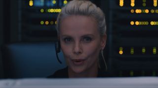 Charlize Theron sitting behind a computer in The Fate of the Furious