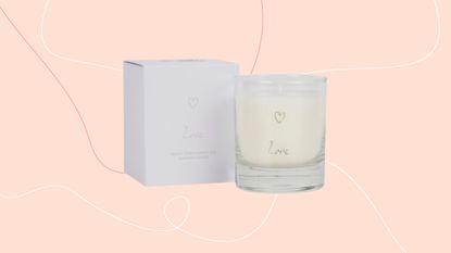 The White Company Love charity candle against pink background