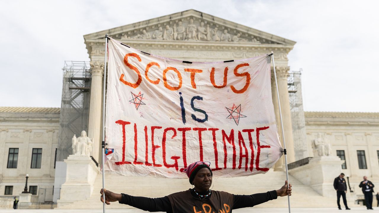 A protester outside the U.S. Supreme Court on February 8, 2024 in Washington, DC. The court heard oral arguments in a case on whether or not former President Trump can remain on the ballot in Colorado for the 2024 presidential election. 