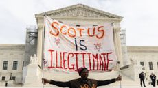 A protester outside the U.S. Supreme Court on February 8, 2024 in Washington, DC. The court heard oral arguments in a case on whether or not former President Trump can remain on the ballot in Colorado for the 2024 presidential election. 