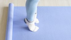 Feet on an exercise mat with heels lifted