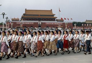 School girls prepare for the reception of French president Georges Pompidou. In the background: Mao portrait and slogans ‘Long live the People's Republic of China. Long live the Union of the people of the world.' fromMagnum China
