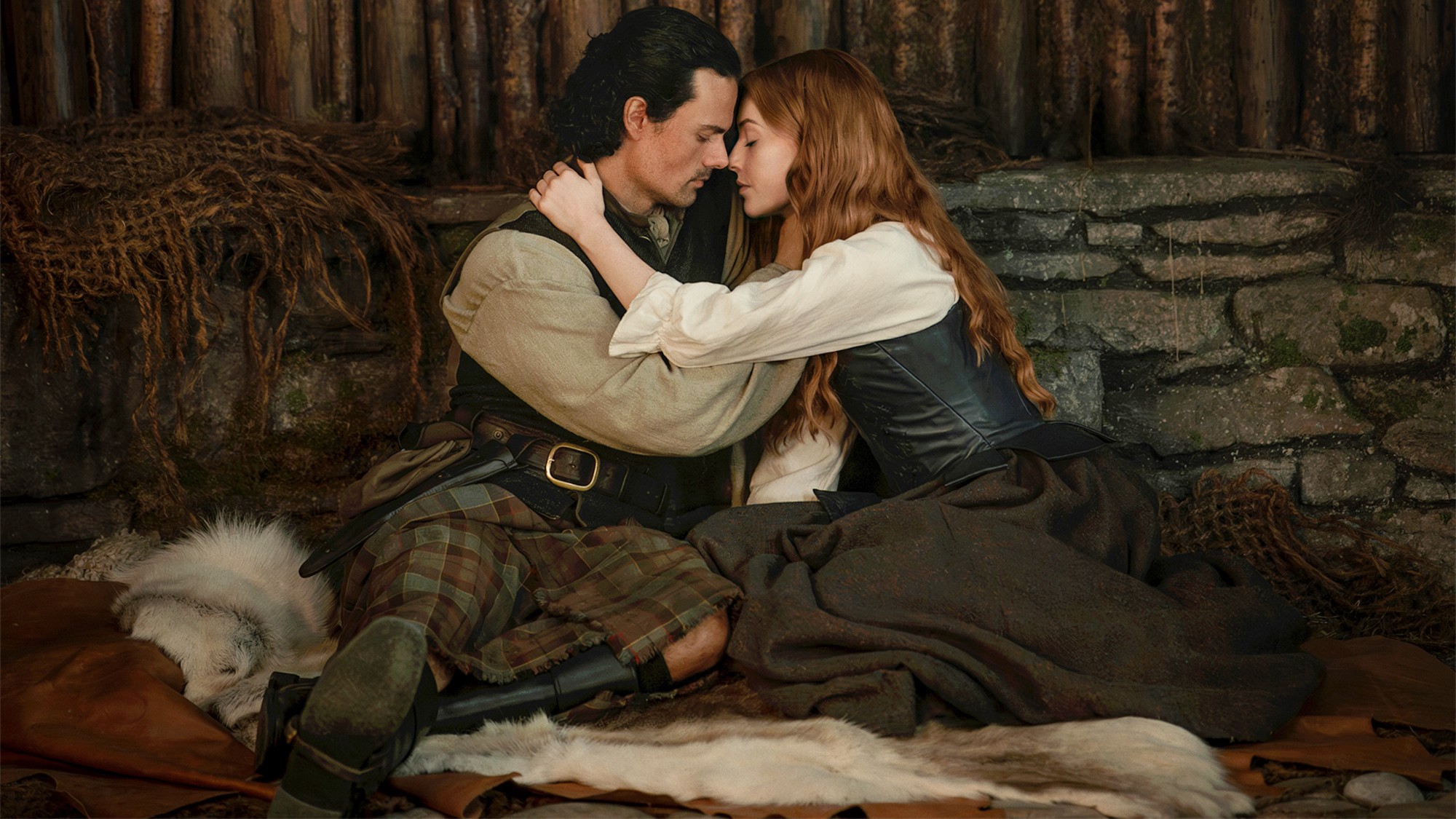 Brian and Ellen holding each other in Outlander: Blood of my Blood. 