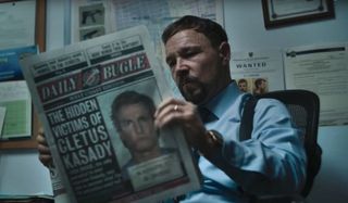 Stephen Graham reading the Daily Bugle at his desk in Venom: Let There Be Carnage.