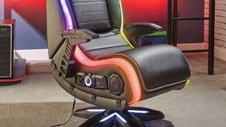 The XRocker Evo Elite 4.1 console gaming chair pedestal with its RGB lighting lit up in a living space