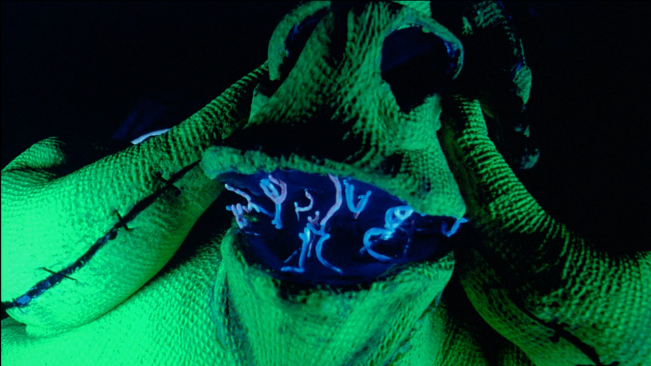 Oogie Boogie holds his face while looking shocked in The Nightmare Before Christmas.