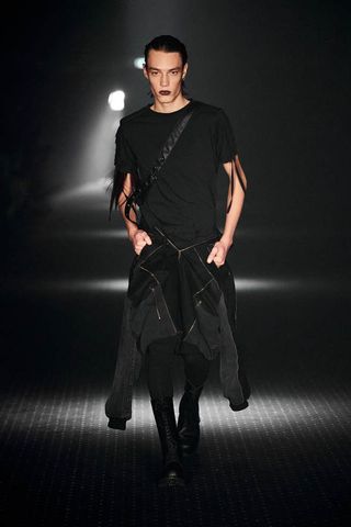 Man on PLN runway in all-black outfit