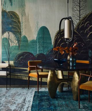 Dark green dining room with forest print wallpaper