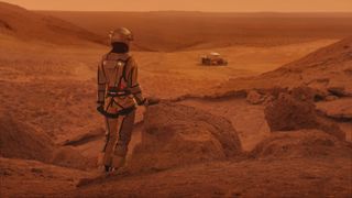 Red dirt on Mars surface. Woman wearing futuristic exoskeleton exploring cave and mountain areas.
